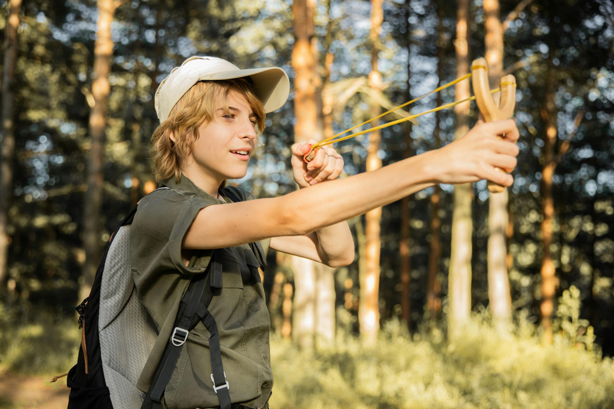 Photo by KATRIN BOLOVTSOVA: https://www.pexels.com/photo/teenager-on-an-adventure-in-a-forest-shooting-from-a-slingshot-5036754/